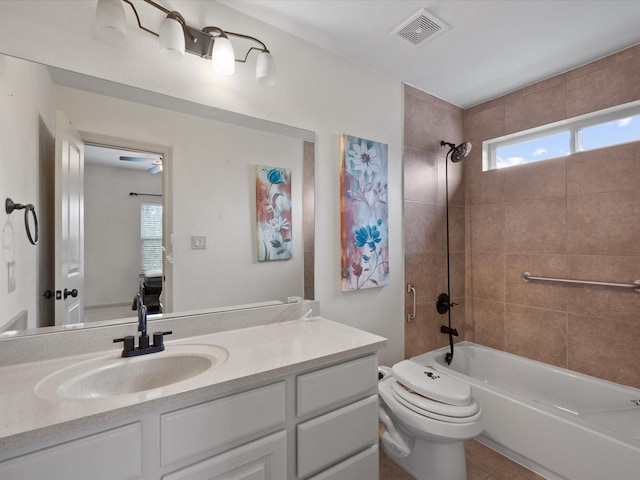 full bathroom with vanity, ceiling fan, tile patterned flooring, toilet, and tiled shower / bath