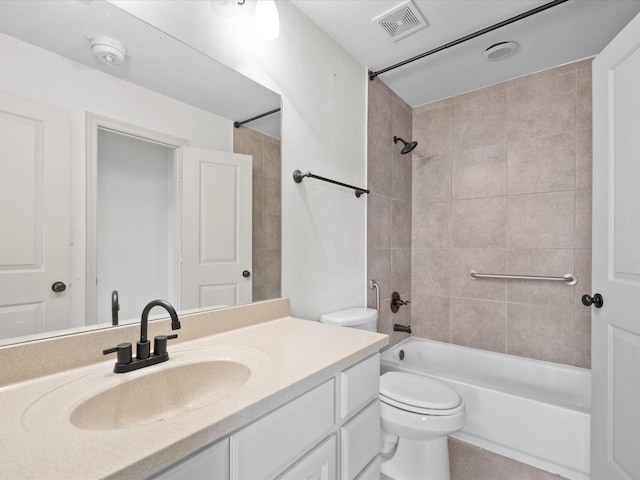 full bathroom with tile patterned floors, toilet, tiled shower / bath combo, and vanity