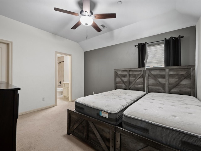 carpeted bedroom featuring ensuite bath, ceiling fan, and vaulted ceiling