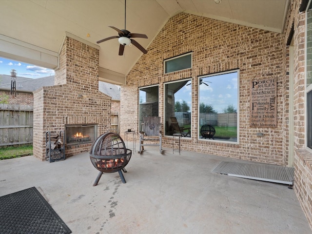 view of patio featuring an outdoor brick fireplace and ceiling fan