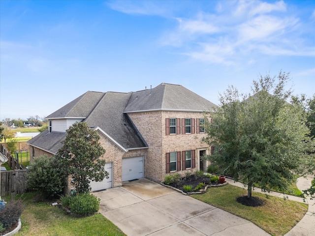 view of front of home with a garage and a front lawn