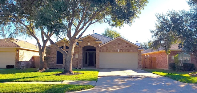 ranch-style home featuring a garage and a front lawn