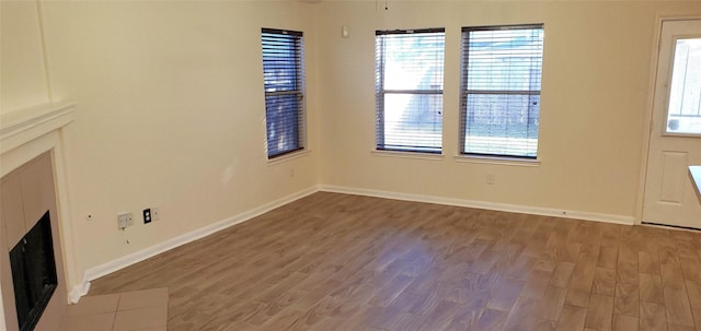 unfurnished living room featuring hardwood / wood-style flooring and a fireplace