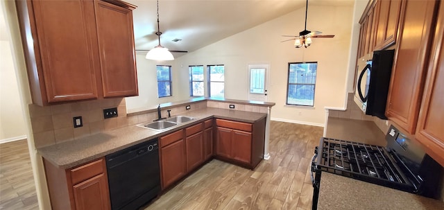 kitchen featuring sink, kitchen peninsula, pendant lighting, black appliances, and light wood-type flooring