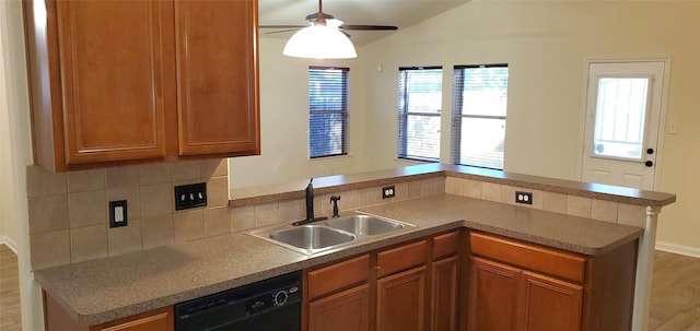 kitchen with wood-type flooring, sink, ceiling fan, black dishwasher, and kitchen peninsula