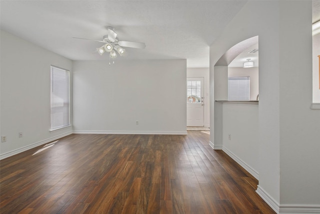 spare room featuring dark hardwood / wood-style floors and ceiling fan