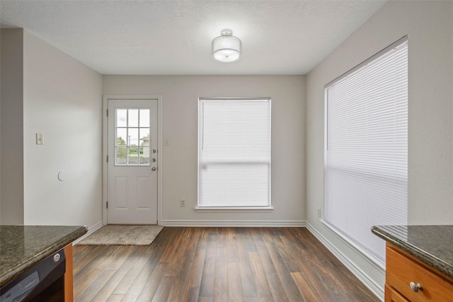 entryway with a textured ceiling and dark hardwood / wood-style floors