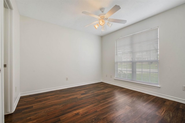 unfurnished room with dark hardwood / wood-style floors and ceiling fan