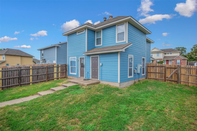 rear view of property with a yard