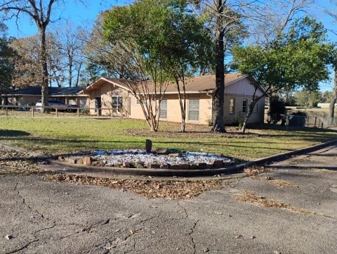 single story home featuring a front yard