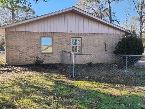 view of side of home with a lawn