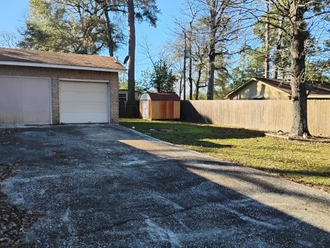 view of yard with a garage and a storage shed