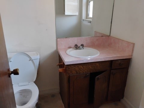 bathroom featuring vanity and toilet