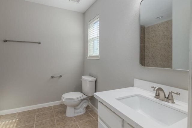 bathroom featuring vanity, tile patterned floors, and toilet