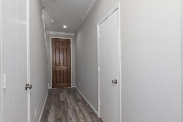 hallway with ornamental molding and dark hardwood / wood-style floors