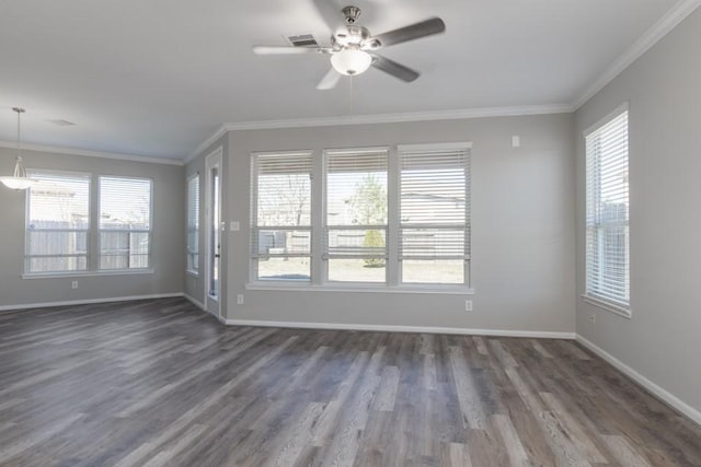 unfurnished room featuring ornamental molding and a wealth of natural light