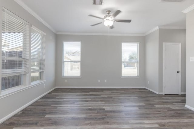 empty room featuring dark wood-type flooring, ceiling fan, and crown molding