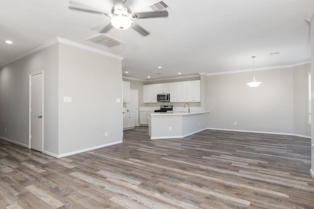 unfurnished living room featuring sink, crown molding, wood-type flooring, and ceiling fan