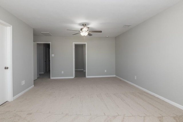 empty room featuring light carpet and ceiling fan