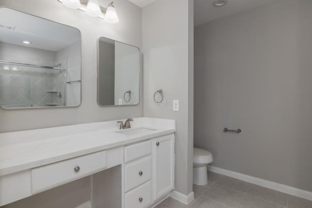 bathroom featuring tile patterned flooring, vanity, tiled shower, and toilet