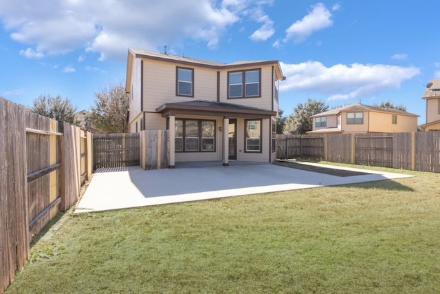 rear view of property featuring a yard and a patio