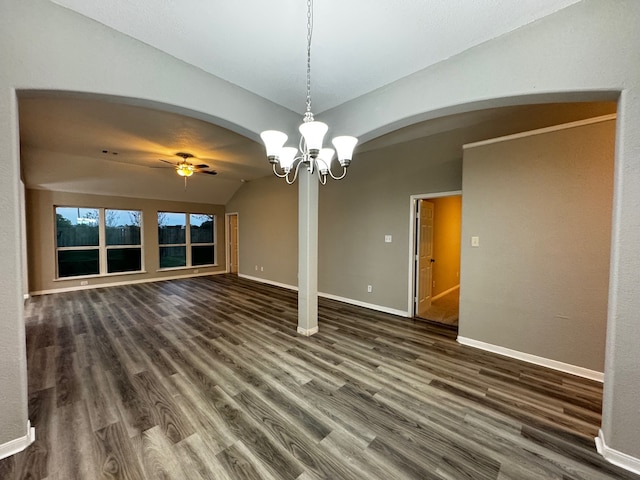 interior space featuring ceiling fan with notable chandelier, dark wood-type flooring, and lofted ceiling