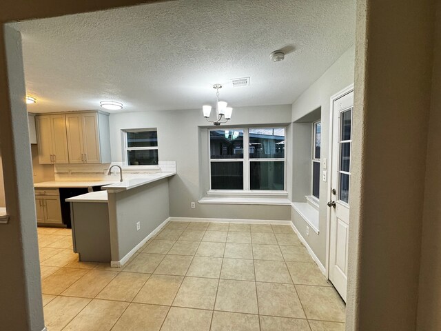 kitchen with a textured ceiling, light tile patterned flooring, decorative light fixtures, and an inviting chandelier