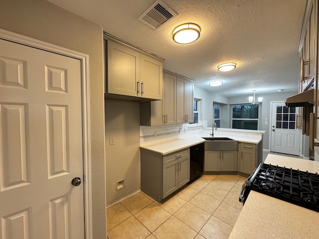 kitchen with gray cabinetry, sink, a textured ceiling, light tile patterned floors, and black appliances