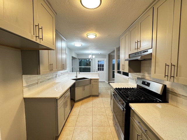 kitchen featuring gas stove, tasteful backsplash, sink, and black dishwasher