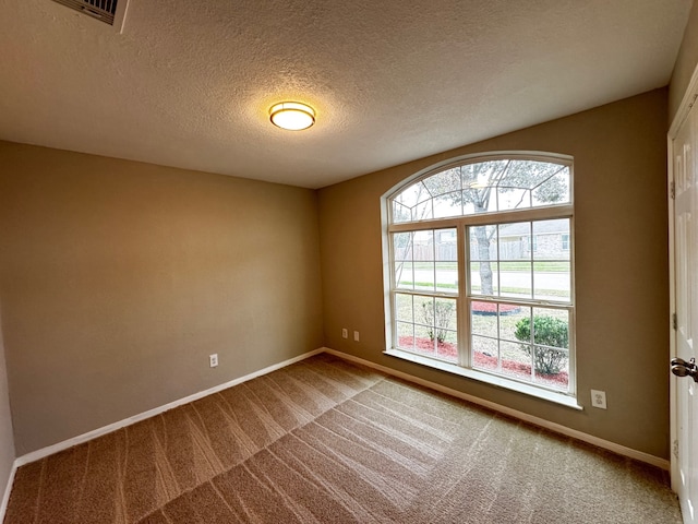 unfurnished room featuring carpet flooring and a textured ceiling