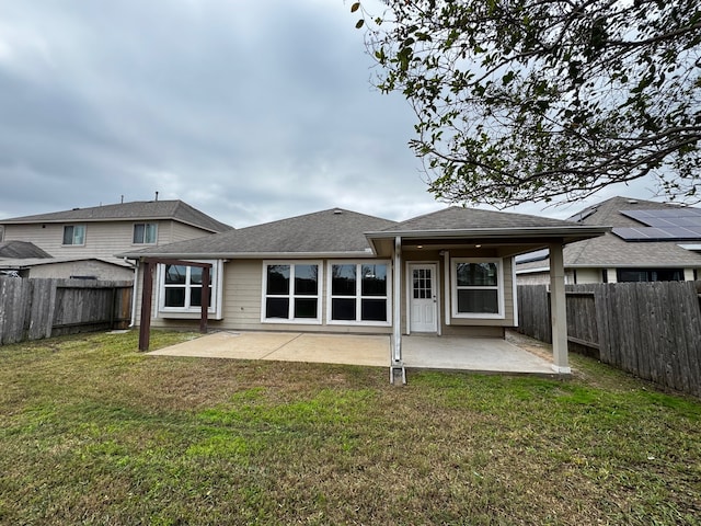 rear view of property with a yard and a patio