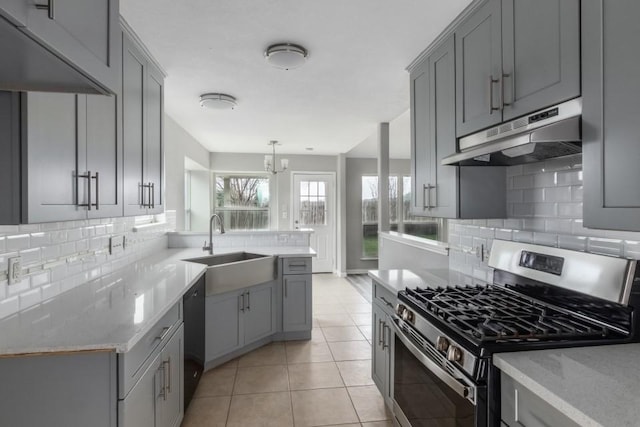 kitchen featuring gray cabinets, stainless steel gas range oven, black dishwasher, and sink