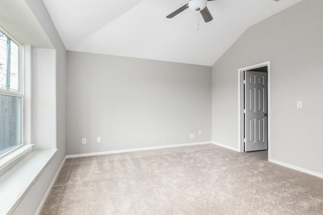 carpeted empty room with lofted ceiling and ceiling fan