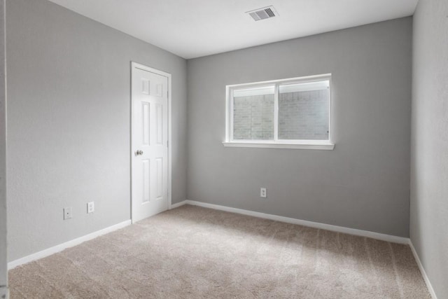 unfurnished room featuring carpet