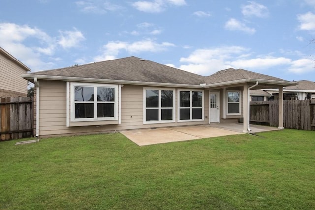 rear view of house with a patio and a lawn