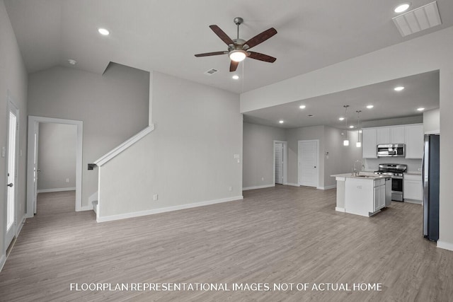 unfurnished living room featuring ceiling fan, light hardwood / wood-style floors, sink, and high vaulted ceiling