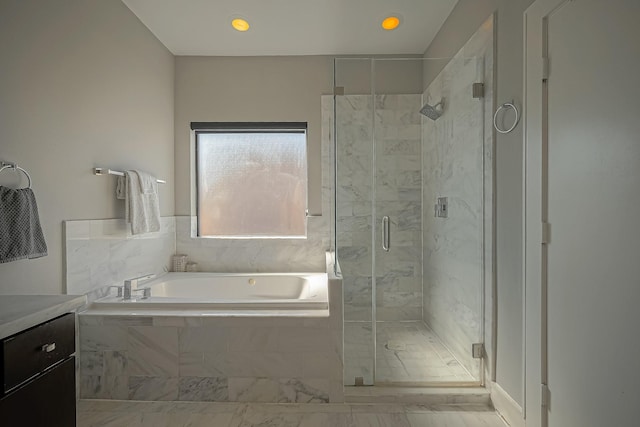 bathroom with separate shower and tub