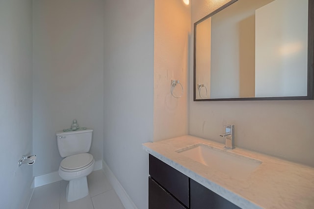 bathroom with tile patterned floors, vanity, and toilet