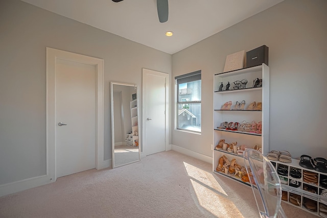 mudroom with ceiling fan and light colored carpet