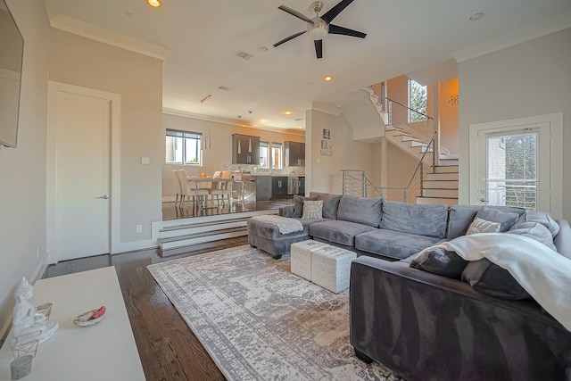 living room with crown molding, ceiling fan, and wood-type flooring