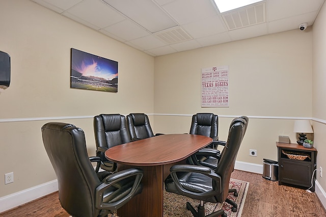 home office featuring a paneled ceiling and dark hardwood / wood-style floors