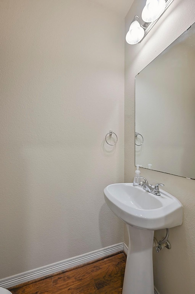 bathroom with hardwood / wood-style floors