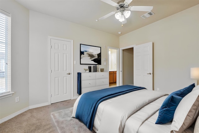 bedroom with light colored carpet, multiple windows, and ceiling fan