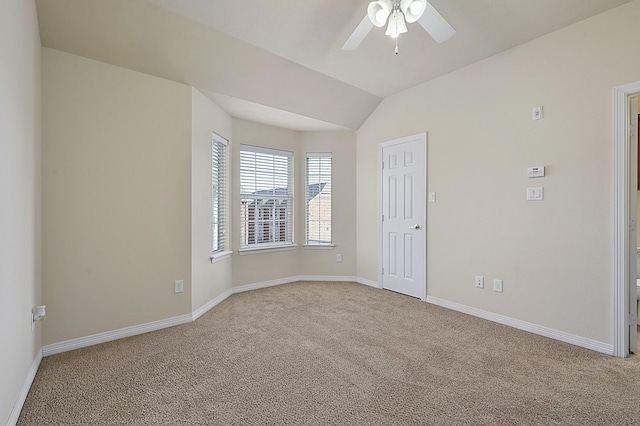 carpeted empty room with ceiling fan and lofted ceiling