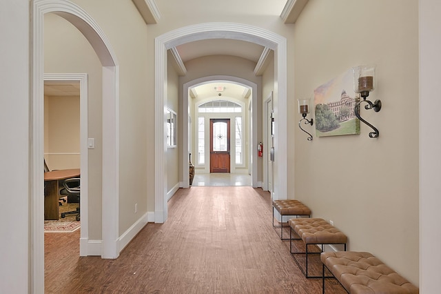 foyer featuring wood-type flooring and vaulted ceiling