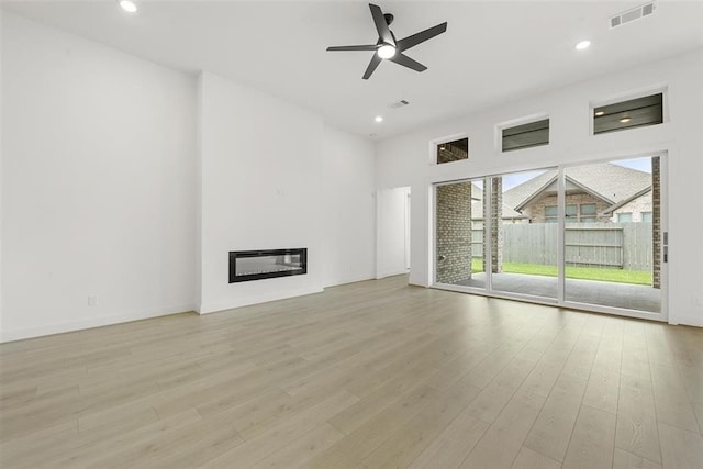 unfurnished living room with light hardwood / wood-style flooring and ceiling fan