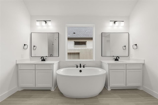 bathroom featuring vanity and a tub to relax in