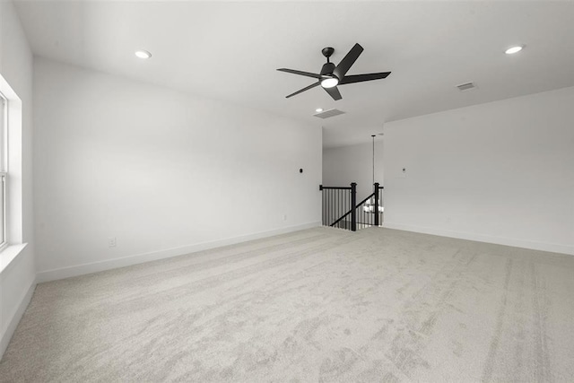 spare room featuring carpet and ceiling fan