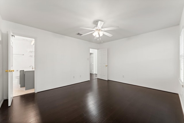 spare room featuring ceiling fan and dark wood-type flooring