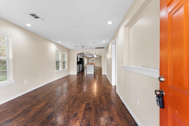 unfurnished living room featuring dark hardwood / wood-style floors